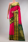 Pink Kanjivaram Silk Saree with Zari Butta on the body and Zari Border.  displayed on a mannequin