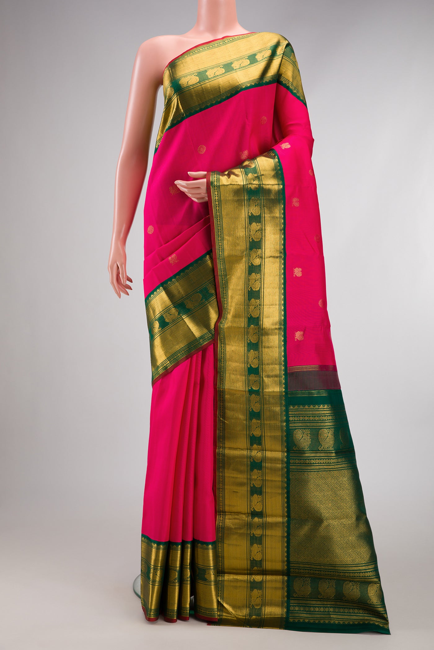 Pink Kanjivaram Silk Saree with Zari Butta on the body and Zari Border.  displayed on a mannequin