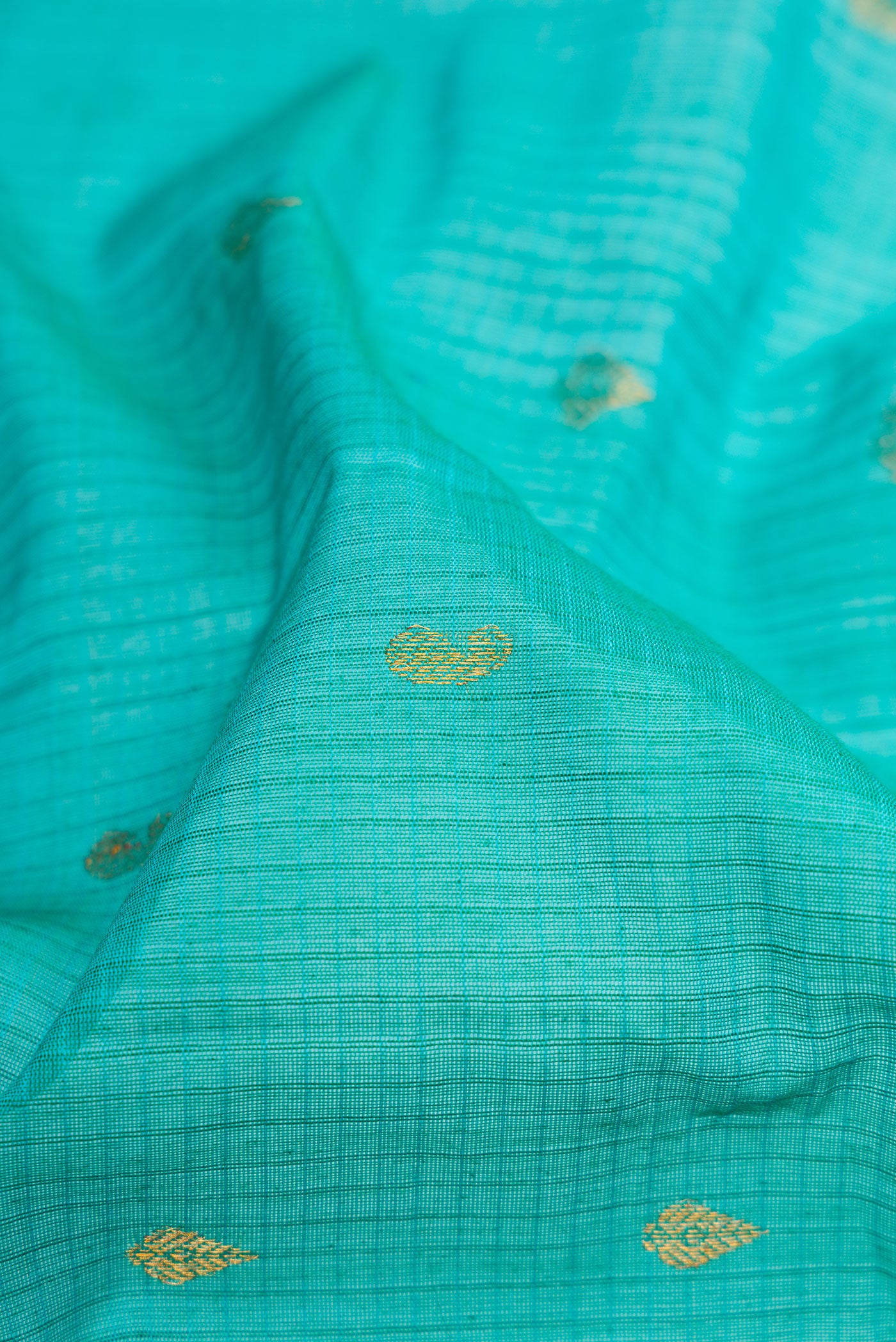 Close up of Sky Blue Gadwal Silk Cotton Saree with Checked design on the body and Zari Border.  displaying folds