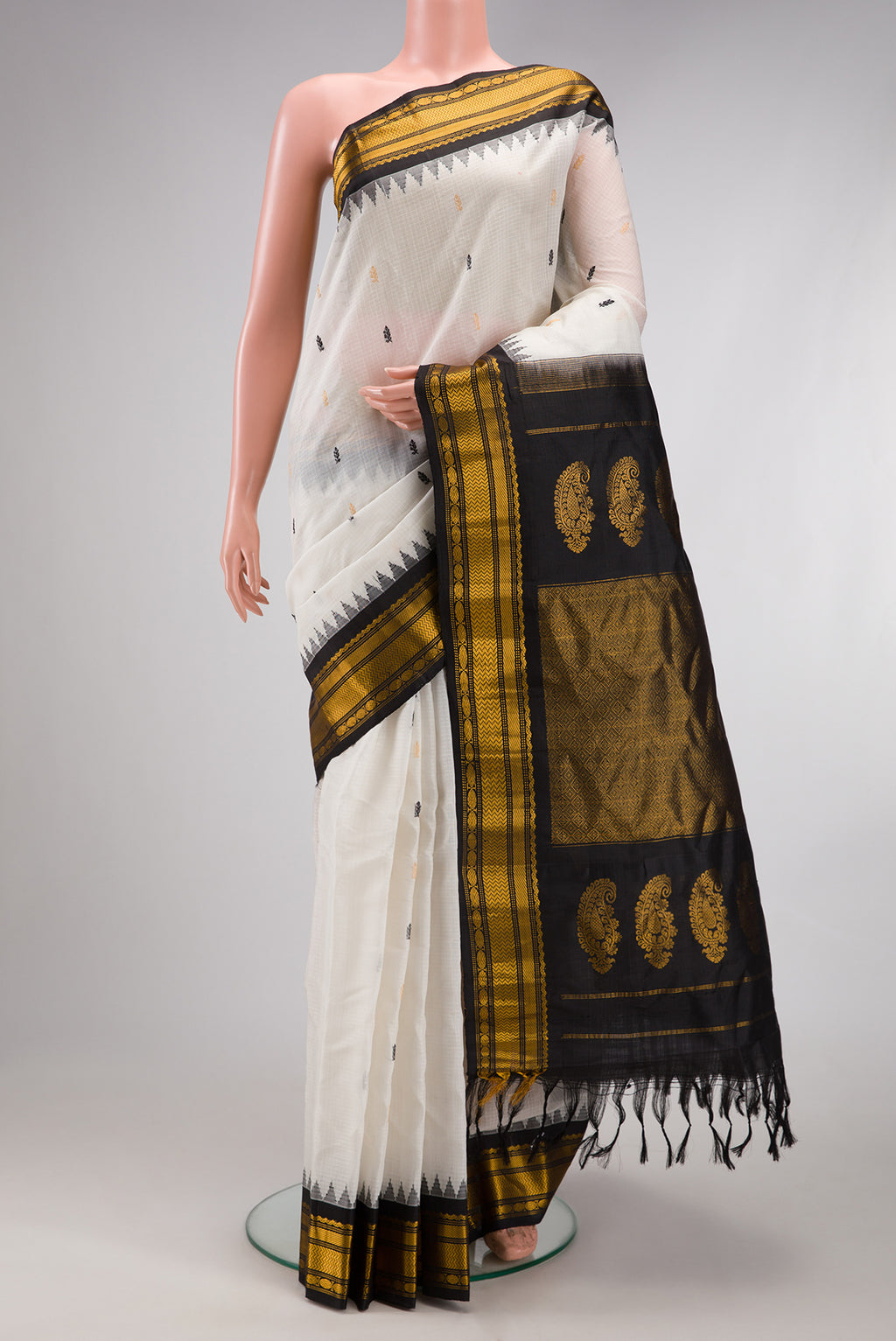 White Gadwal Silk Cotton Saree with Checked design on the body and Zari Border.  displayed on a mannequin