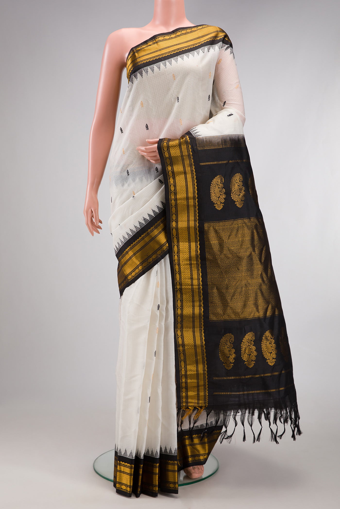 White Gadwal Silk Cotton Saree with Checked design on the body and Zari Border.  displayed on a mannequin