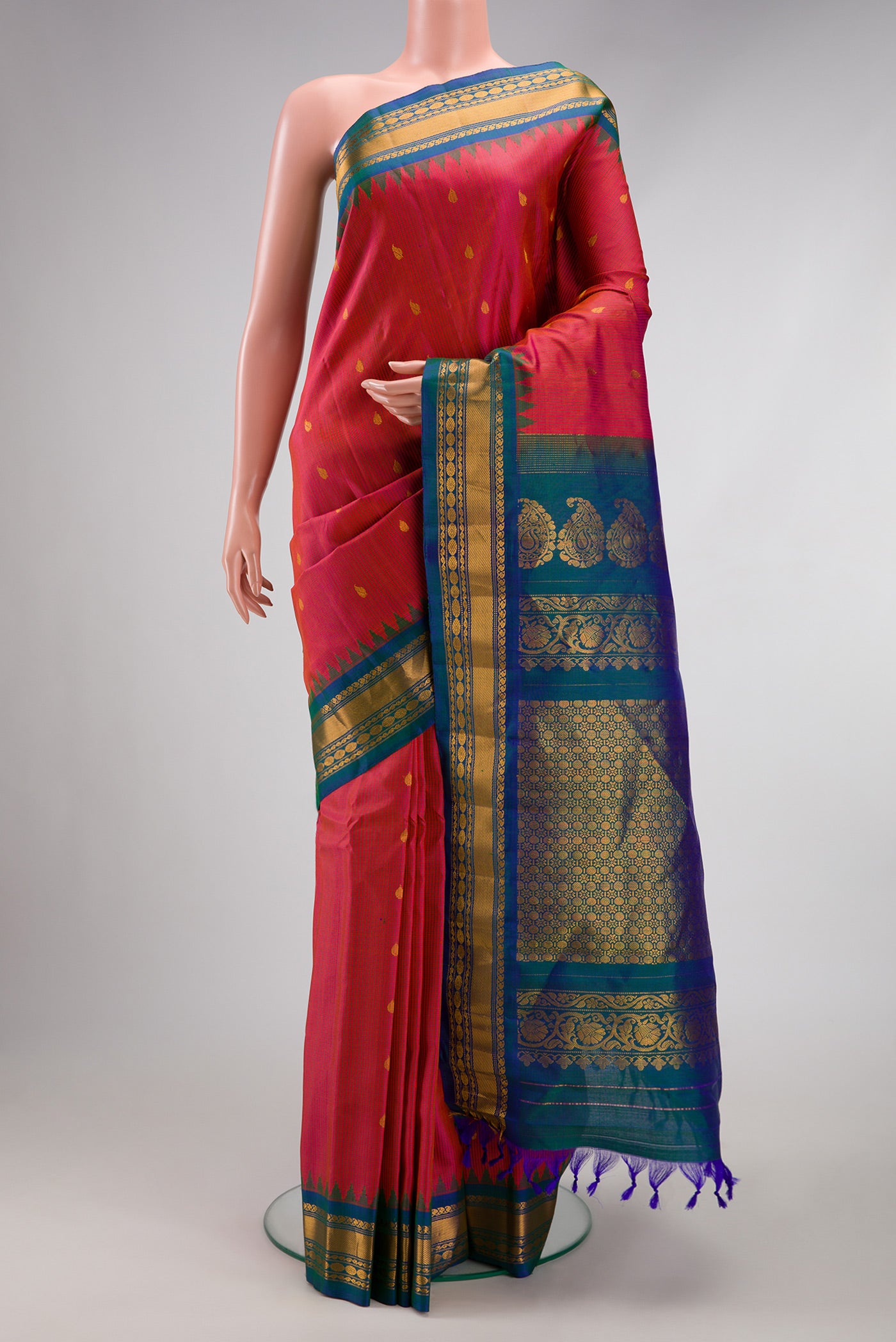 Coral Gadwal Silk Saree with Checked design on the body and Zari Border.  displayed on a mannequin