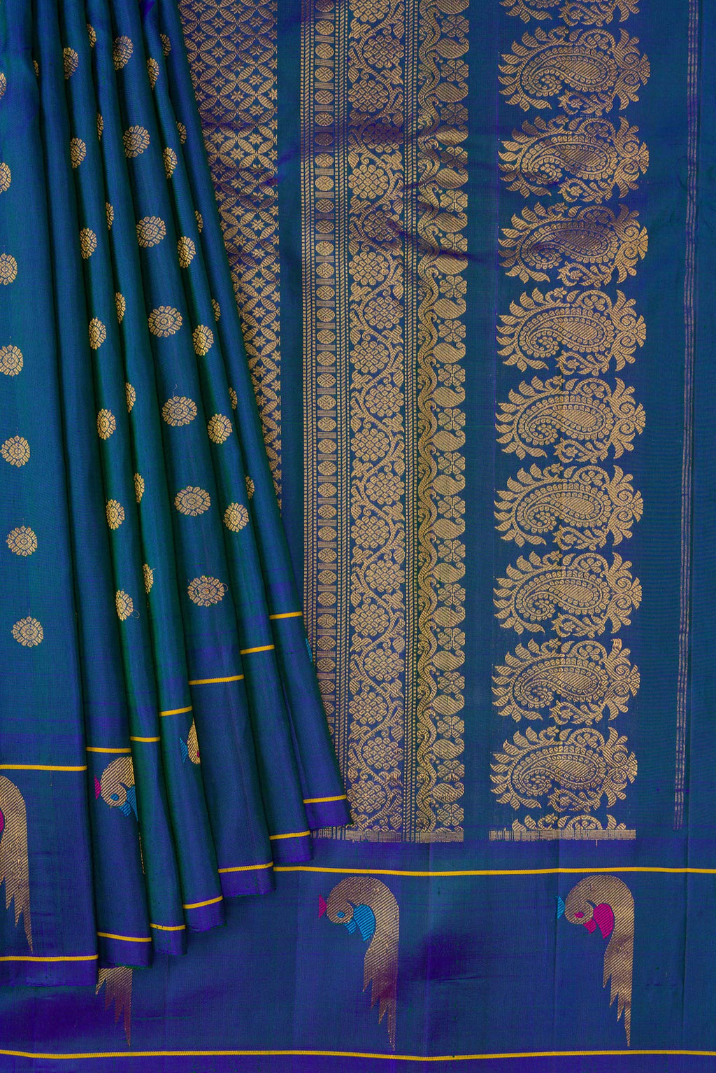 Pleats and pallu of Peacock Blue Dual Tone Gadwal Silk Saree with Zari Butta on the body and Paithani Border. 