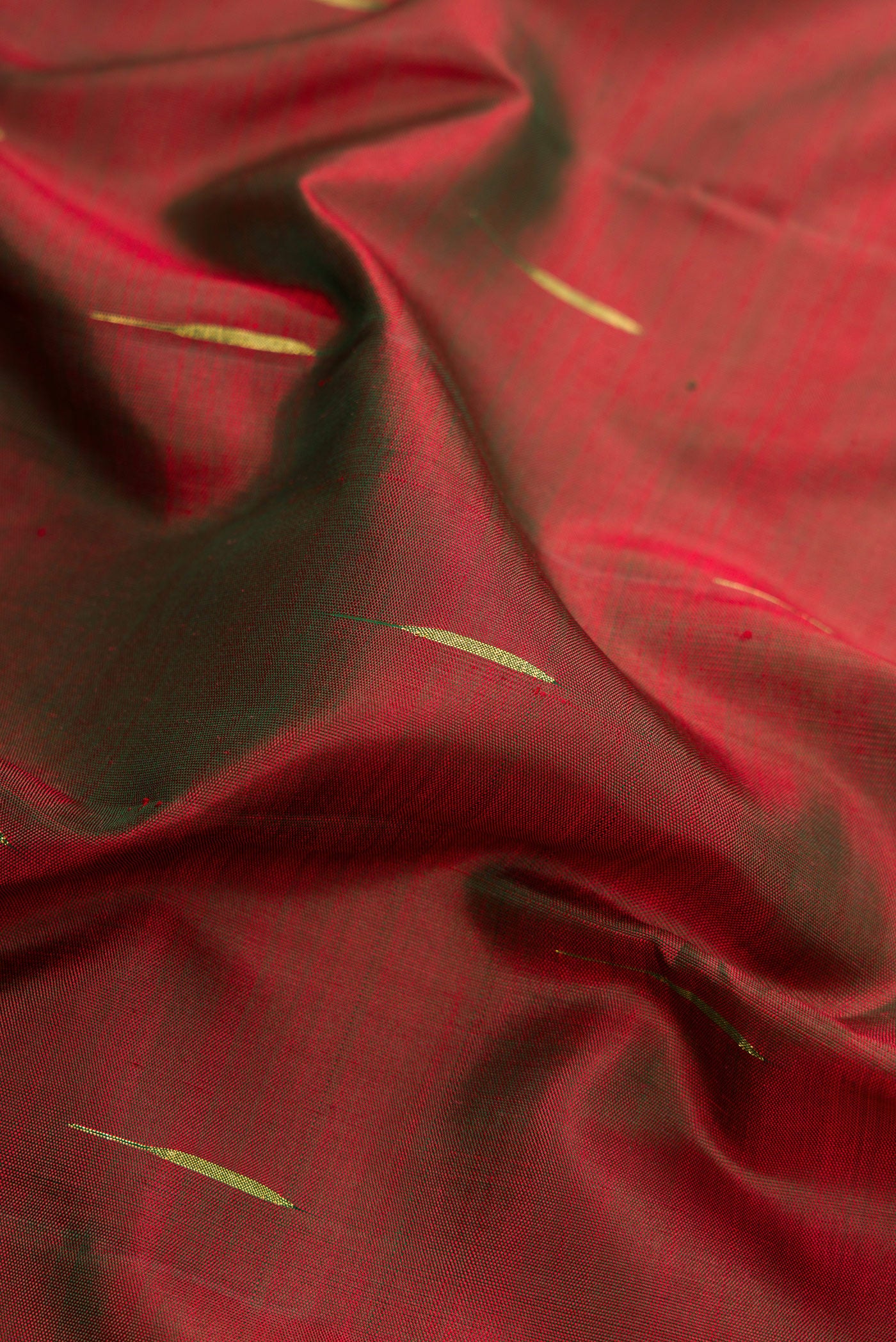 Close up of Mehandi Green Dual Tone Kanjivaram Silk Saree with Zari Butta on the body and Zari Border.  displaying folds