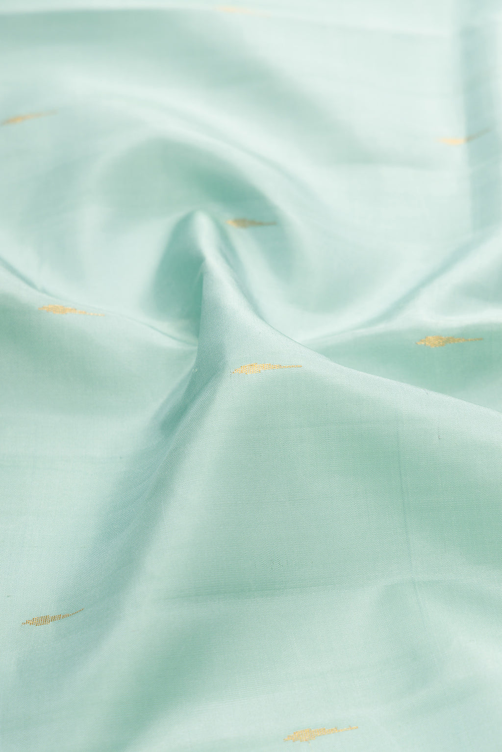 Close up of Light Blue Kanjivaram Silk Saree with Zari Butta on the body and Zari Border.  displaying folds