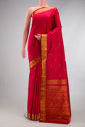 Maroon Kanjivaram Silk Saree with Zari Butta on the body and Zari Border.  displayed on a mannequin