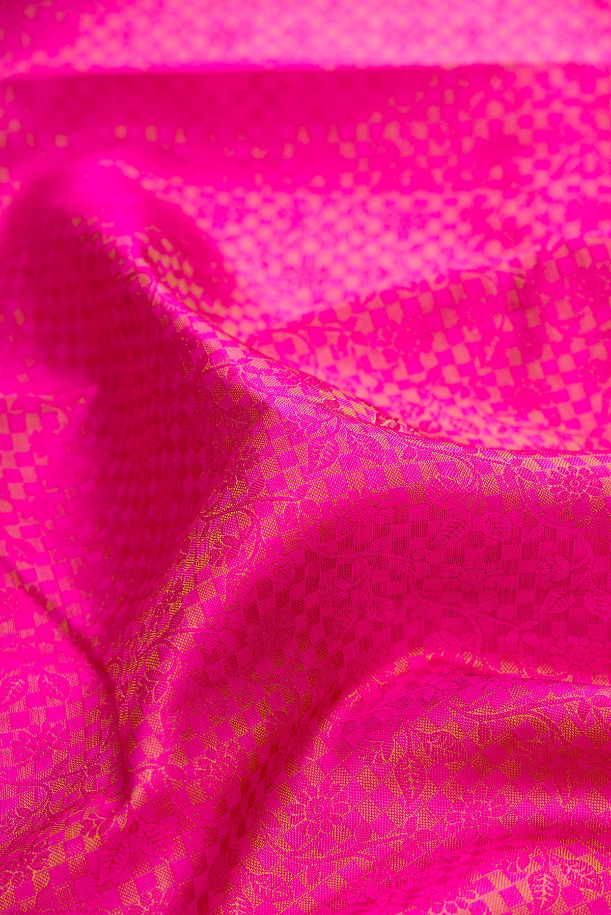 Close up of Pure Silk Pink Dual Tone Kanjivaram Saree with Jacquard design on the body and Zari Border.  displaying folds
