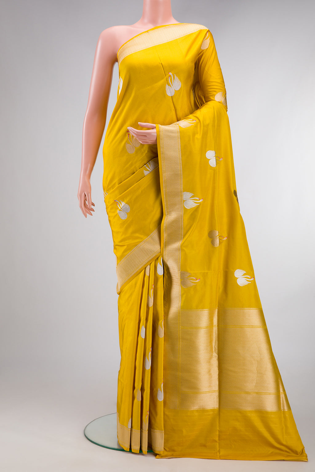 Yellow Dual Tone Banarasi Silk Saree with Zari And Thread Butta on the body and Zari Border.  displayed on a mannequin