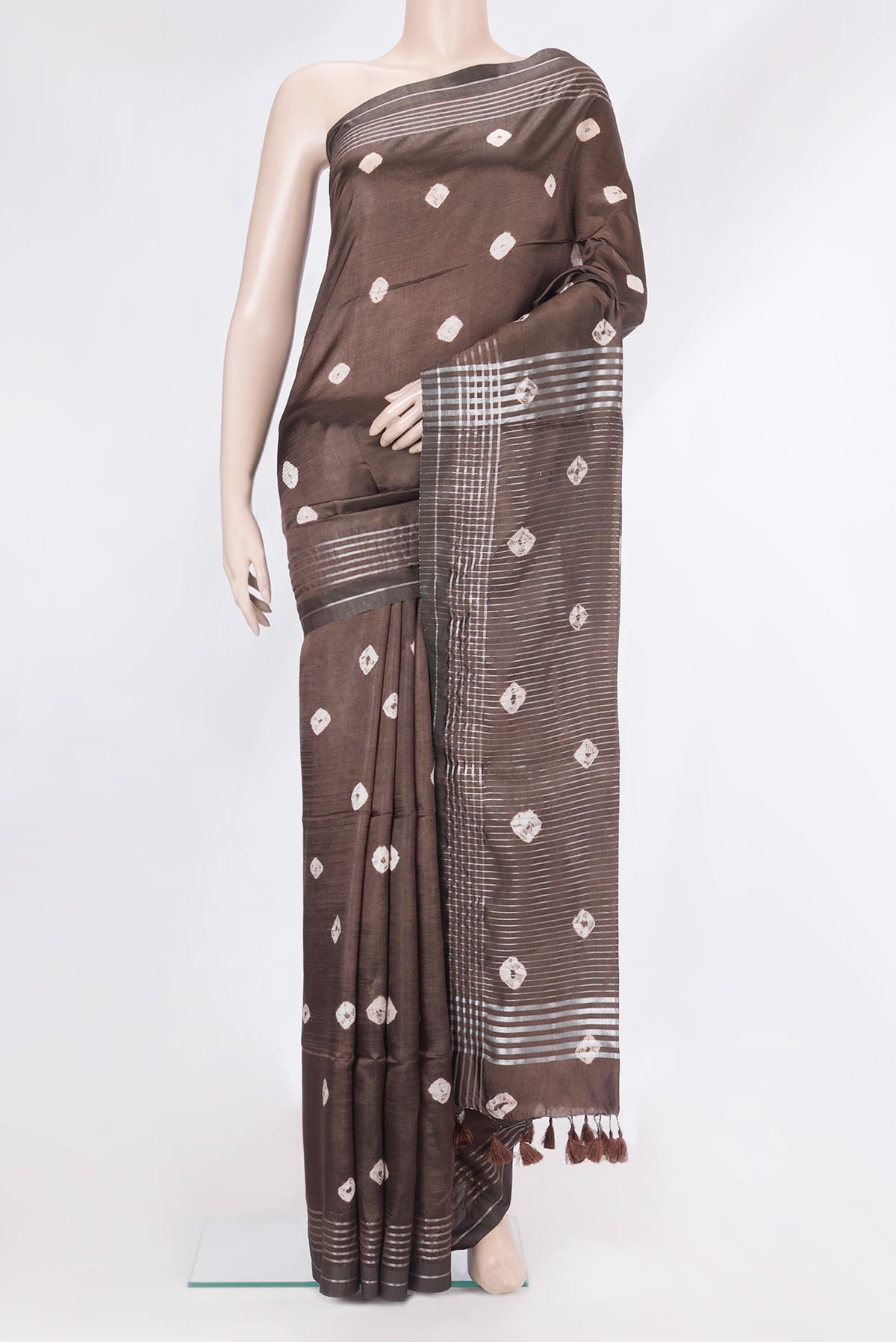 Brown Blended Tussar Silk Saree with Printed design on the body and Zari Border.  displayed on a mannequin