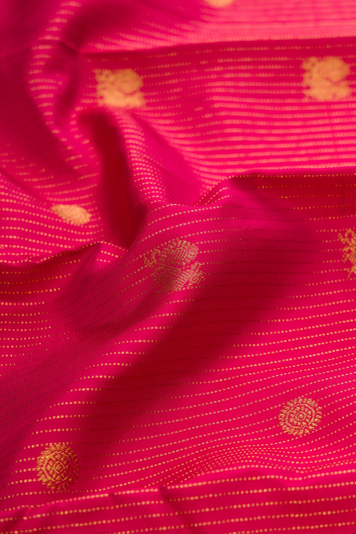 Close up of Maroon Kanchipuram Silk Saree with Stripes on the body and Zari Border.  displaying folds