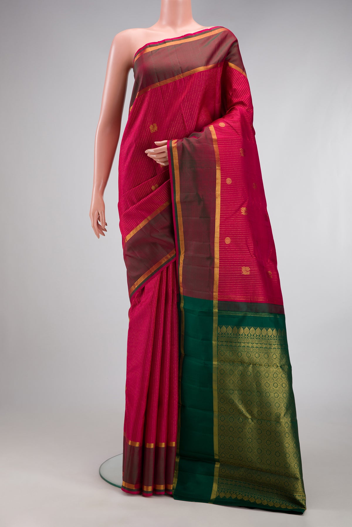 Maroon Kanchipuram Silk Saree with Stripes on the body and Zari Border.  displayed on a mannequin