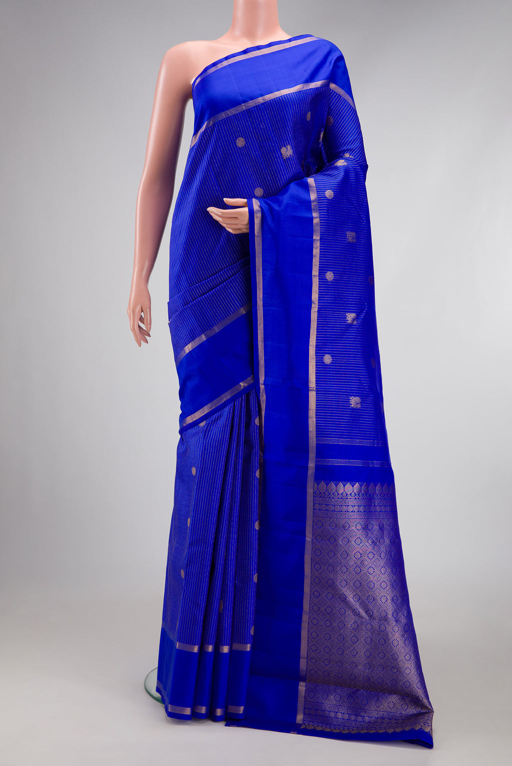 Royal Blue Kanchipuram Silk Saree with Stripes on the body and Zari Border.  displayed on a mannequin