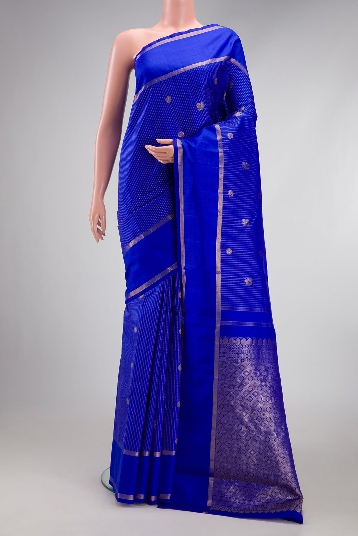 Royal Blue Kanchipuram Silk Saree with Stripes on the body and Zari Border.  displayed on a mannequin