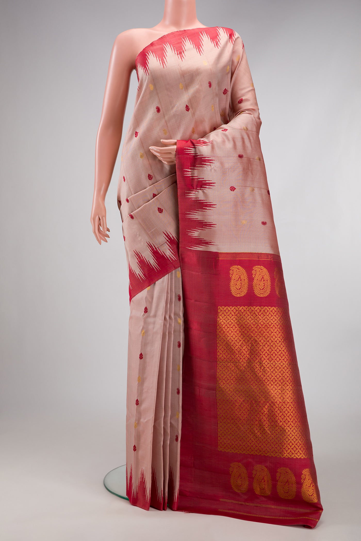 Rose Gold Gadwal Silk Saree with Zari And Thread Butta on the body and Temple Border.  displayed on a mannequin