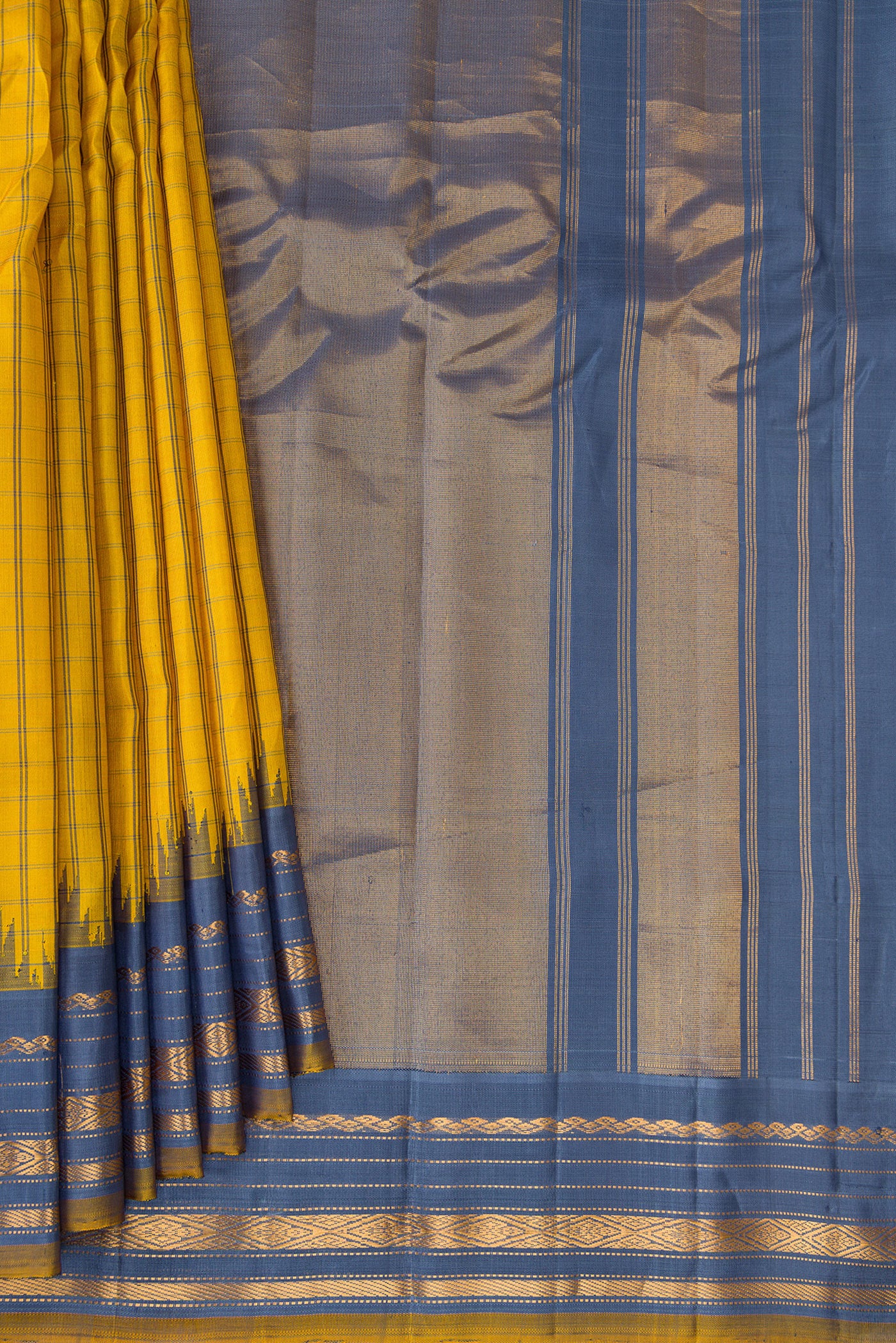 Pleats and pallu of Yellow Gadwal Silk Saree with Checked design on the body and Temple Border. 