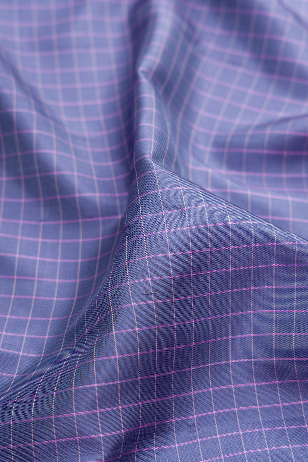 Close up of Grey Gadwal Silk Saree with Checked design on the body and Temple Border.  displaying folds
