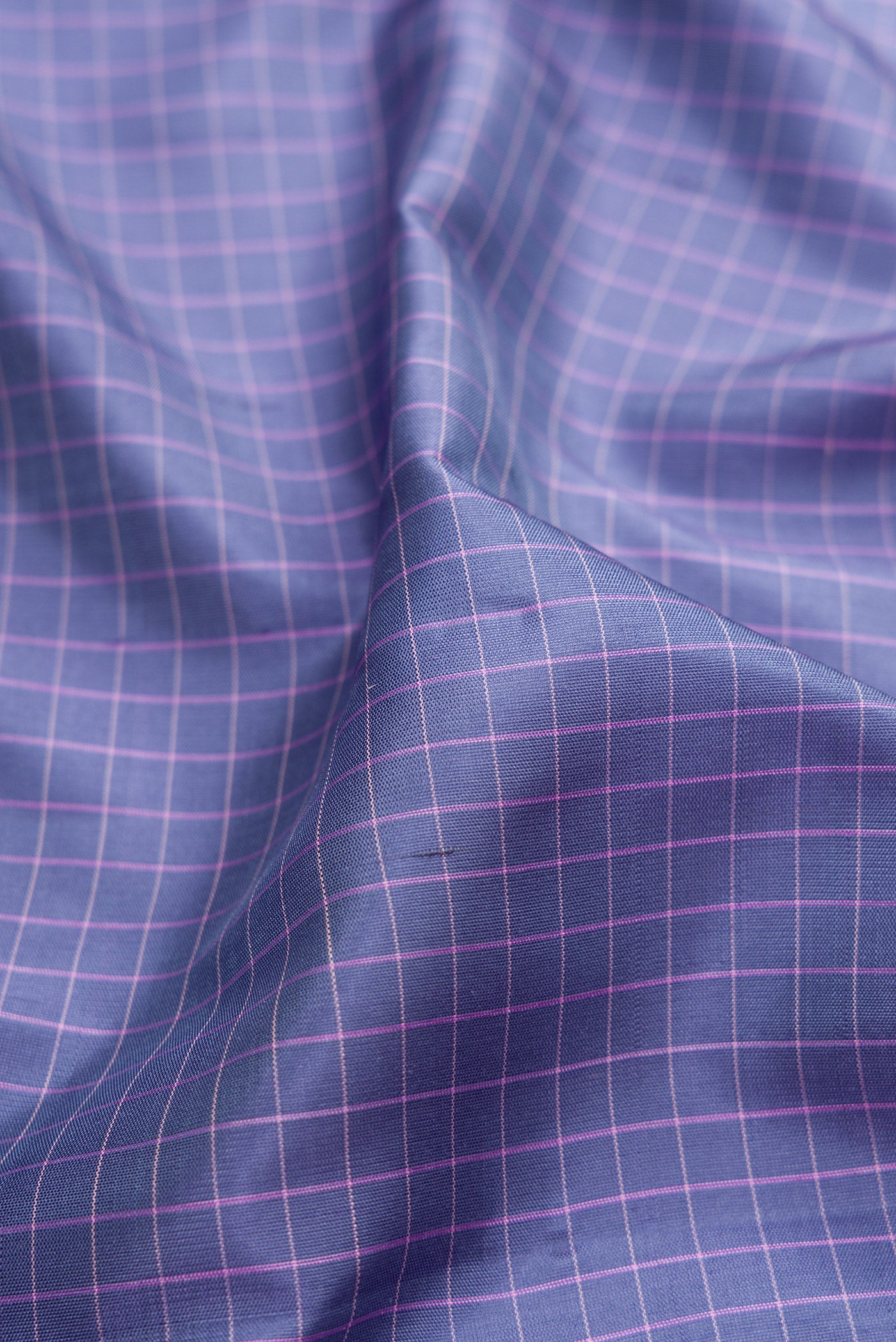 Close up of Grey Gadwal Silk Saree with Checked design on the body and Temple Border.  displaying folds