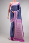 Grey Gadwal Silk Saree with Checked design on the body and Temple Border.  displayed on a mannequin