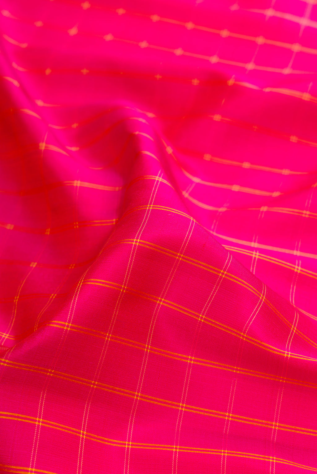 Close up of Pink Gadwal Silk Saree with Checked design on the body and Zari Border.  displaying folds