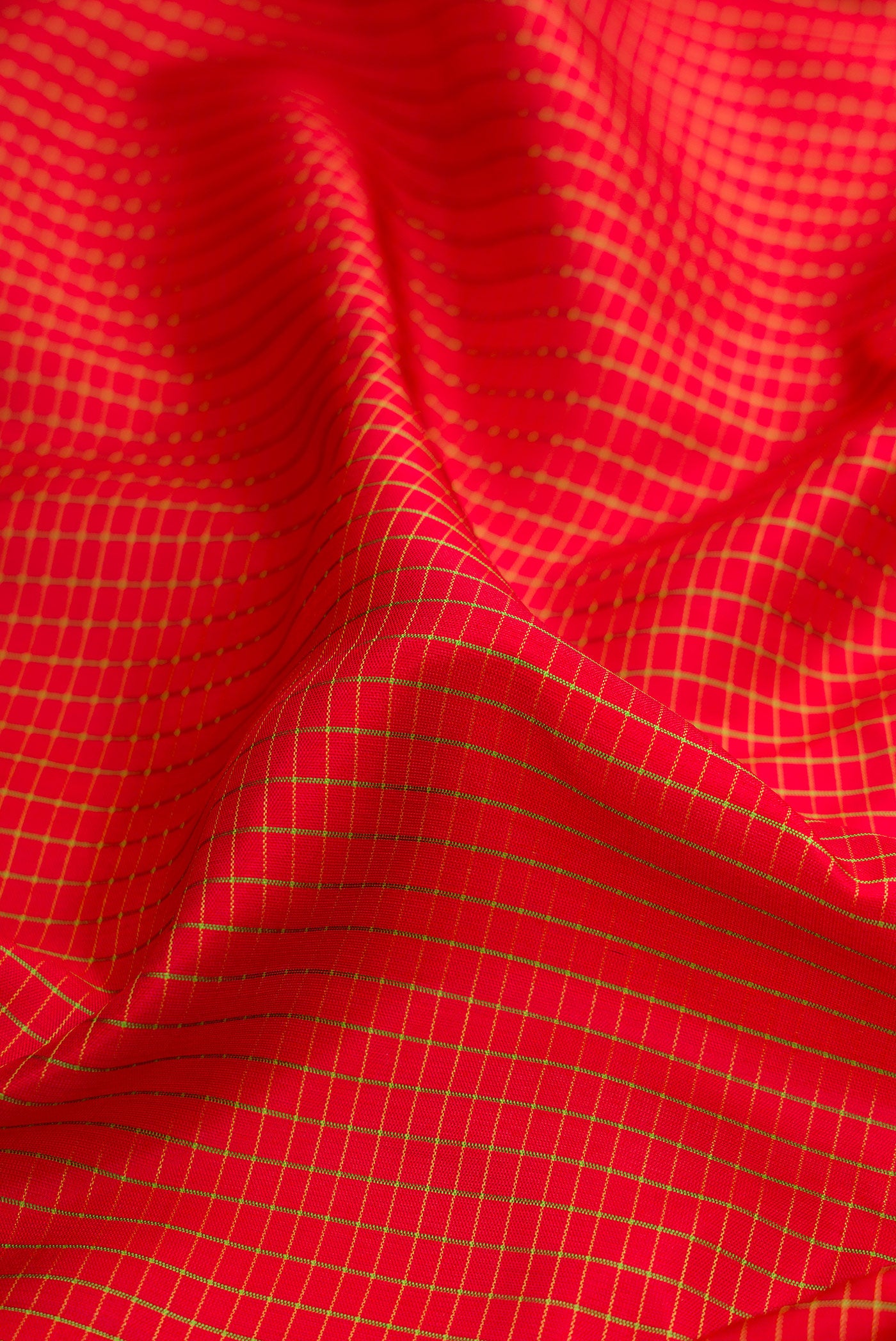 Close up of Maroon Gadwal Silk Saree with Checked design on the body and Zari Border.  displaying folds
