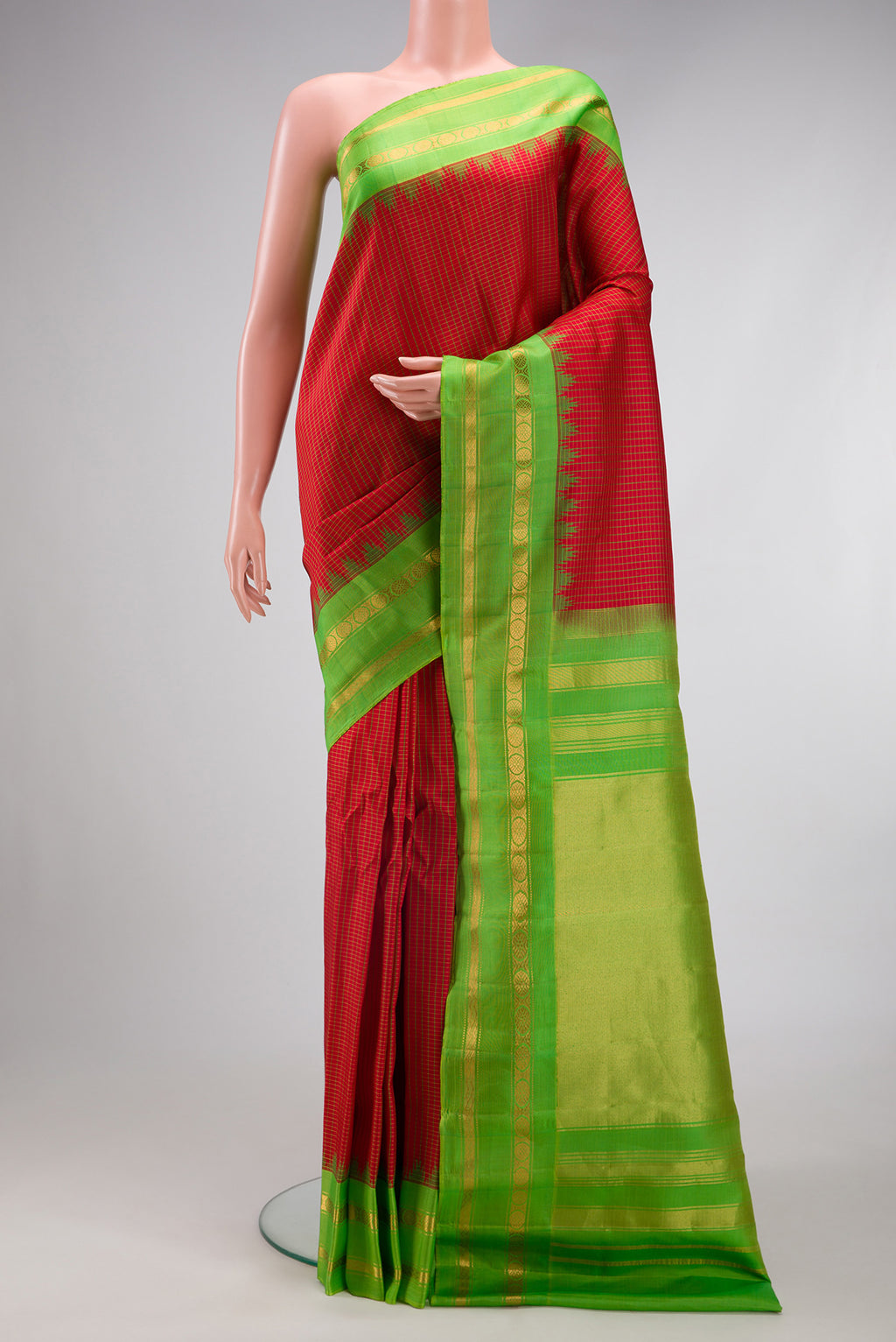 Maroon Gadwal Silk Saree with Checked design on the body and Zari Border.  displayed on a mannequin