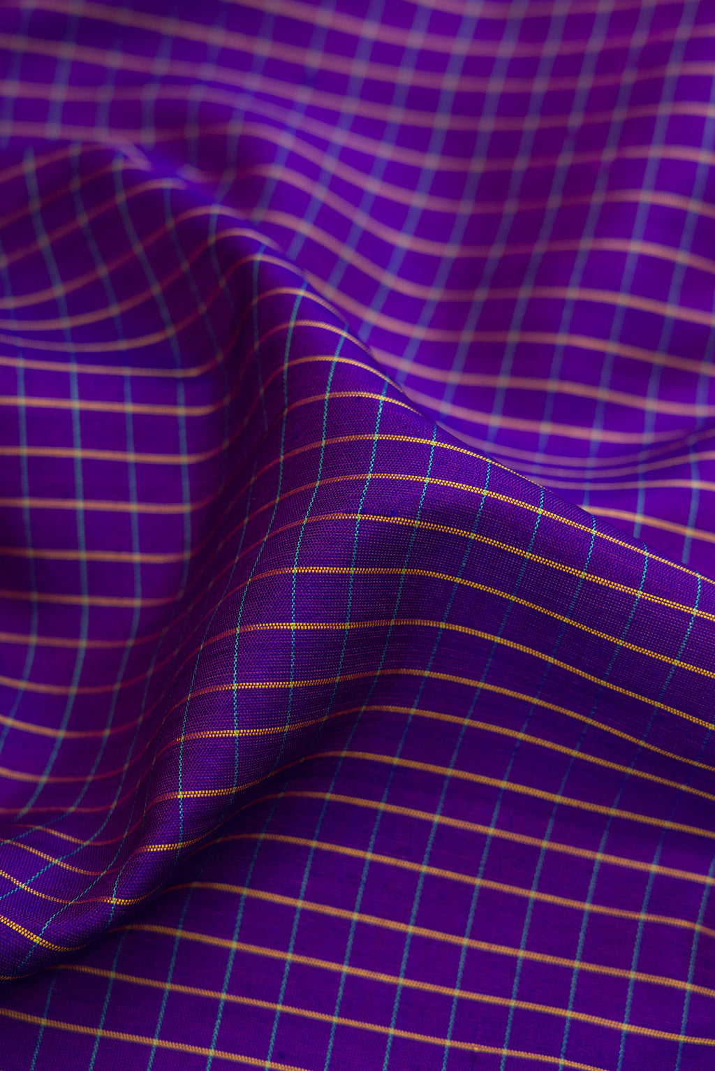 Close up of Dark Blue Gadwal Silk Saree with Checked design on the body and Zari Border.  displaying folds