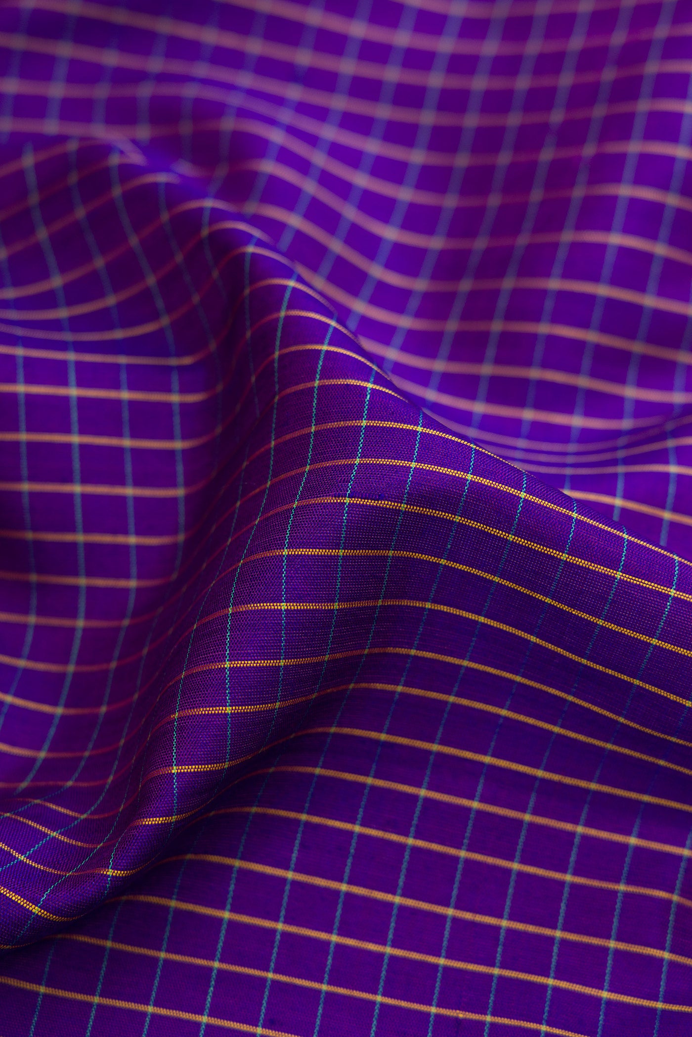 Close up of Dark Blue Gadwal Silk Saree with Checked design on the body and Zari Border.  displaying folds