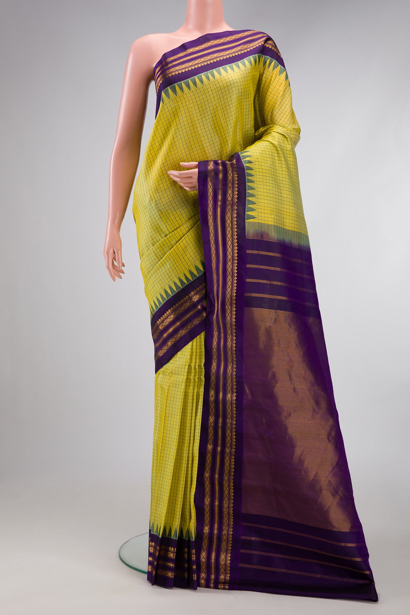 Light Green Gadwal Silk Saree with Checked design on the body and Zari Border.  displayed on a mannequin
