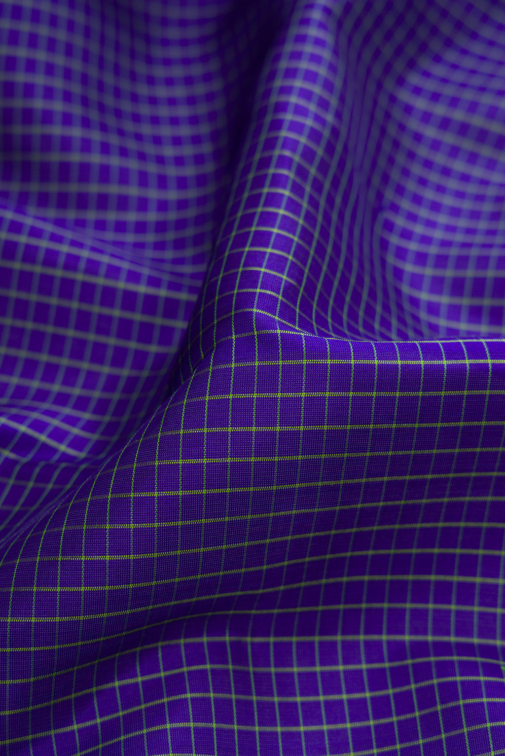 Close up of Royal Blue Gadwal Silk Saree with Checked design on the body and Temple Border.  displaying folds