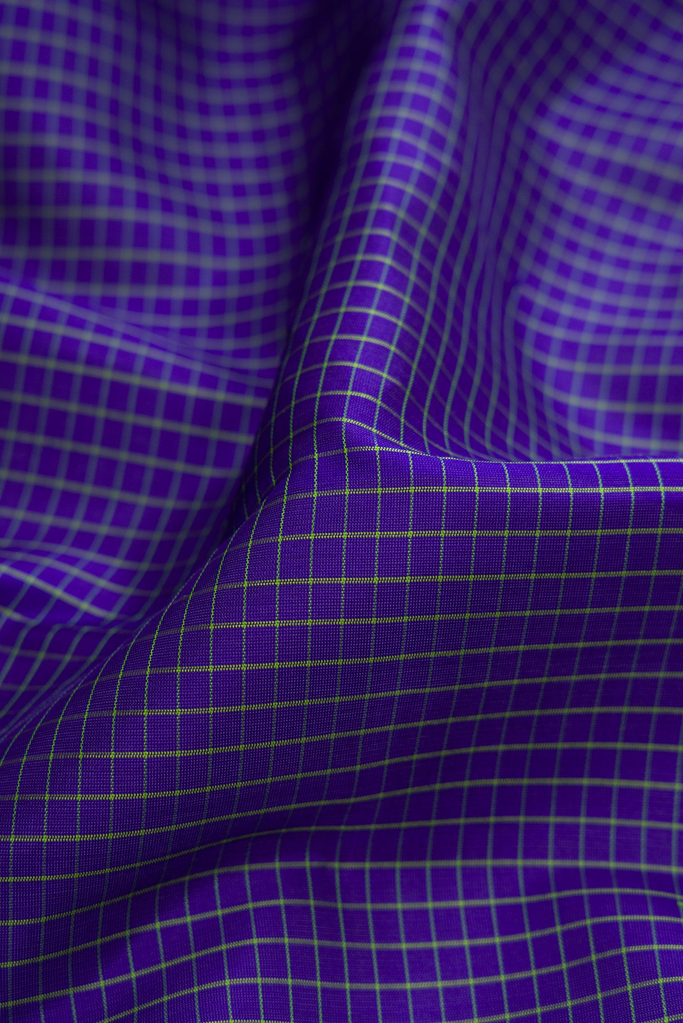 Close up of Royal Blue Gadwal Silk Saree with Checked design on the body and Temple Border.  displaying folds