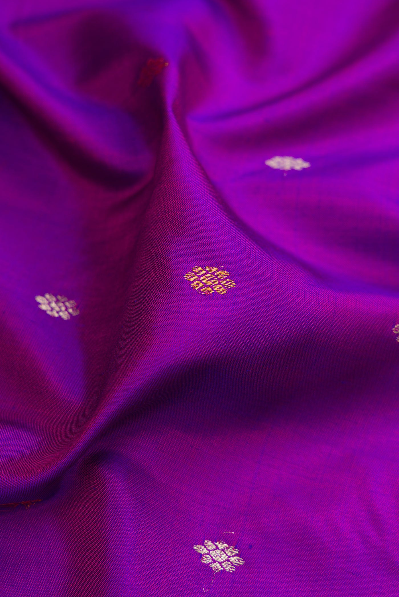 Close up of Purple Gadwal Silk Saree with Zari Butta on the body and Zari Border.  displaying folds