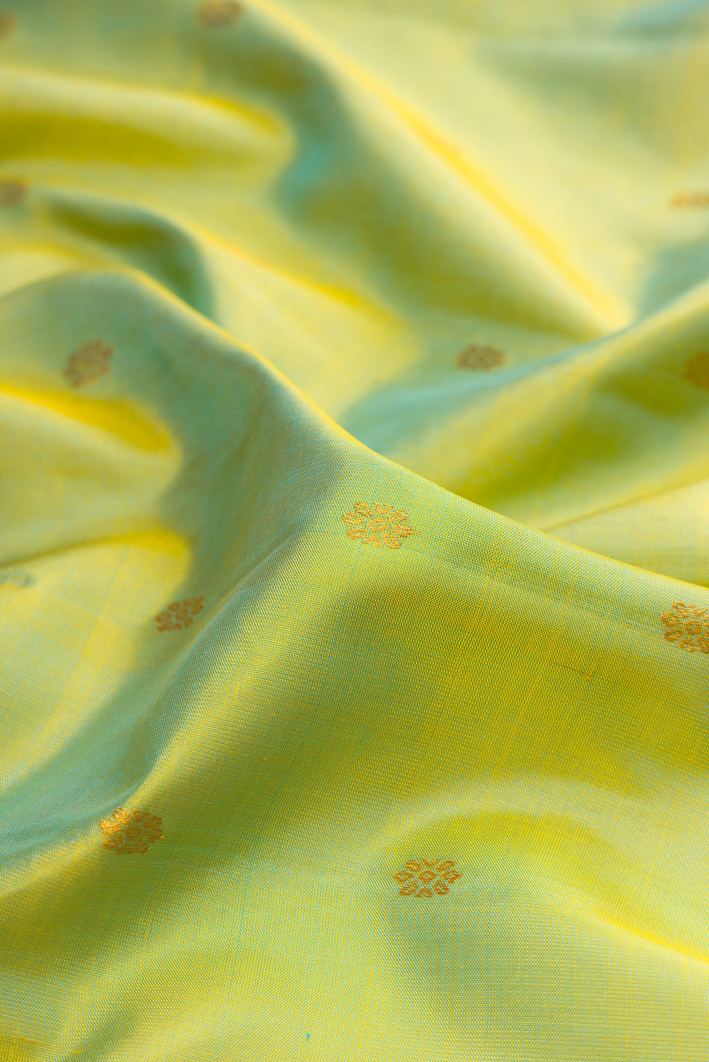 Close up of Pista Green Gadwal Silk Saree with Zari Butta on the body and Zari Border.  displaying folds
