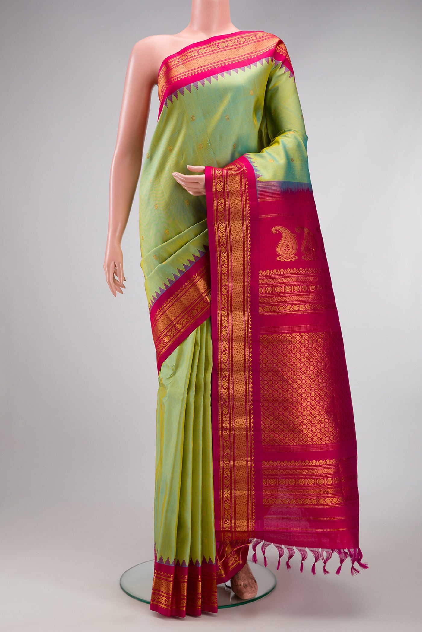 Pista Green Gadwal Silk Saree with Zari Butta on the body and Zari Border.  displayed on a mannequin