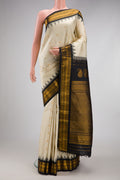 Off White Gadwal Silk Saree with Zari Butta on the body and Temple Border.  displayed on a mannequin