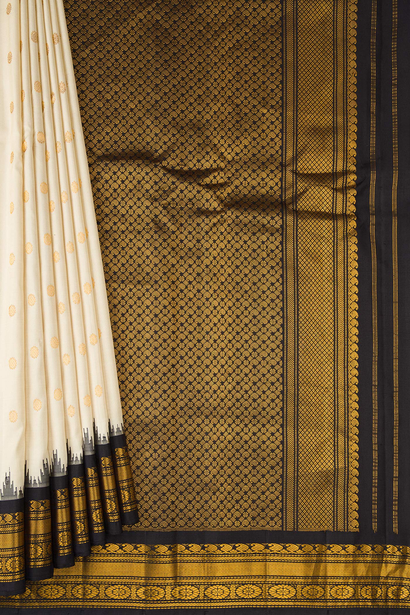 Pleats and pallu of Off White Gadwal Silk Saree with Zari Butta on the body and Temple Border. 