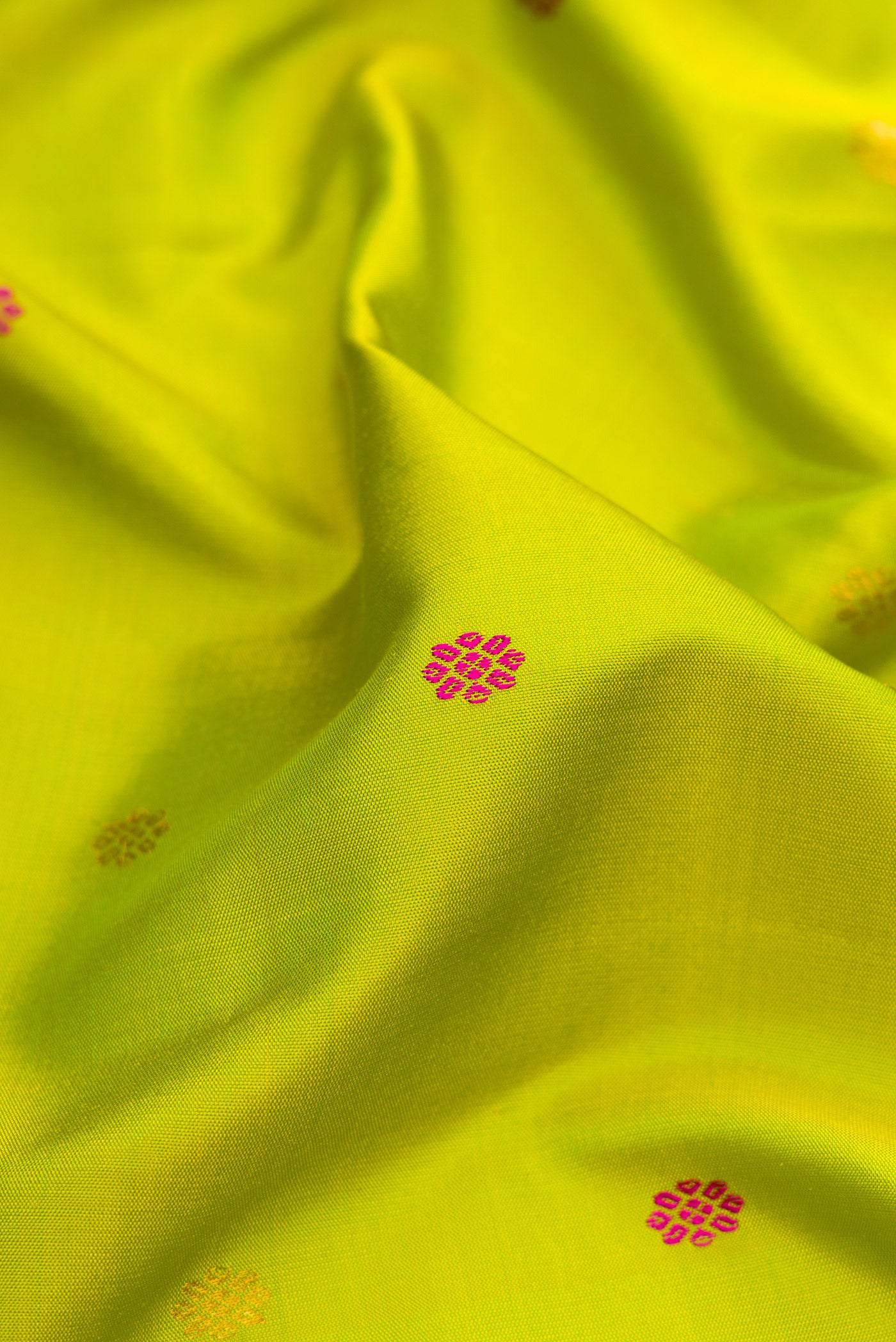 Close up of Parrot Green Gadwal Silk Saree with Zari And Thread Butta on the body and Temple Border.  displaying folds