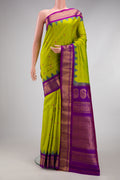 Parrot Green Gadwal Silk Saree with Zari And Thread Butta on the body and Temple Border.  displayed on a mannequin