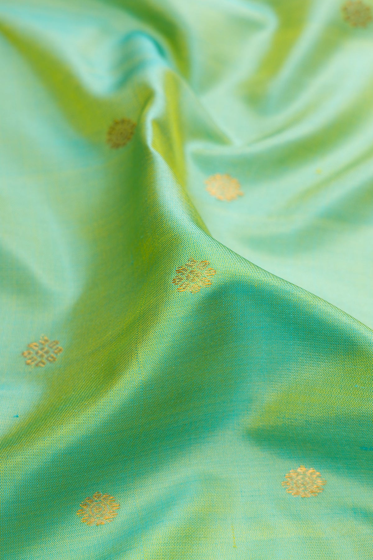 Close up of Pista Green Gadwal Silk Saree with Zari Butta on the body and Temple Border.  displaying folds