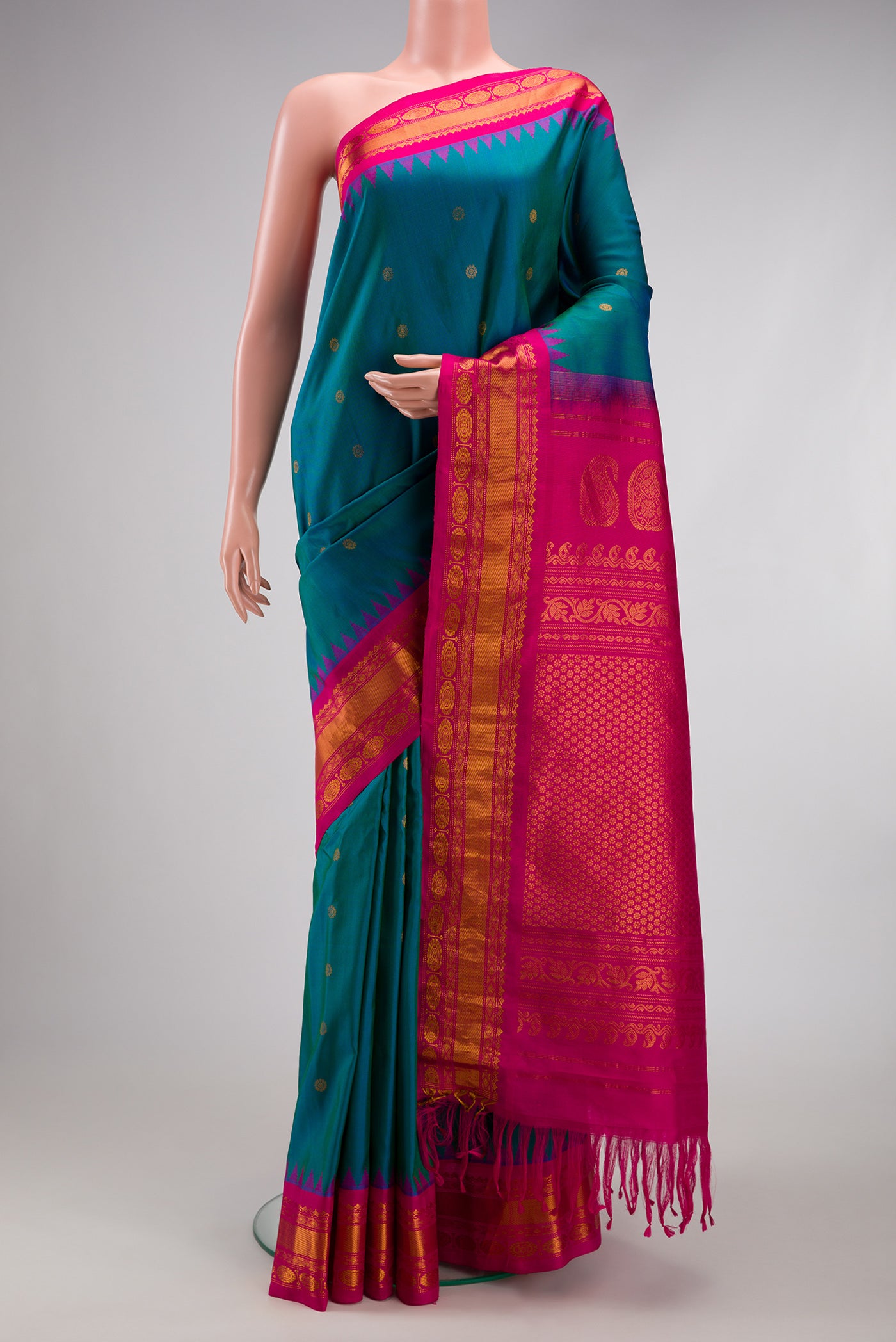 Peacock Blue Gadwal Silk Saree with Zari Butta on the body and Zari Border.  displayed on a mannequin