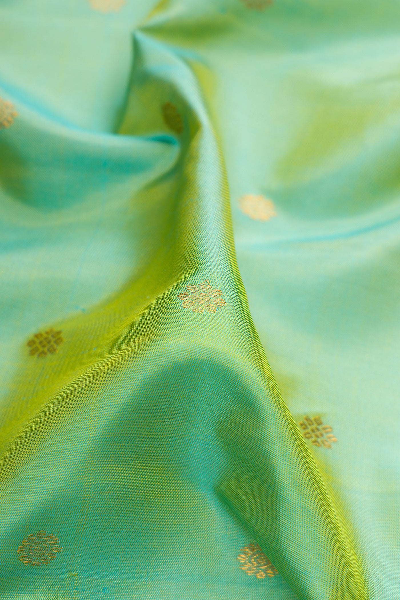 Close up of Light Green Dual Tone Gadwal Silk Saree with Zari Butta on the body and Zari Border.  displaying folds