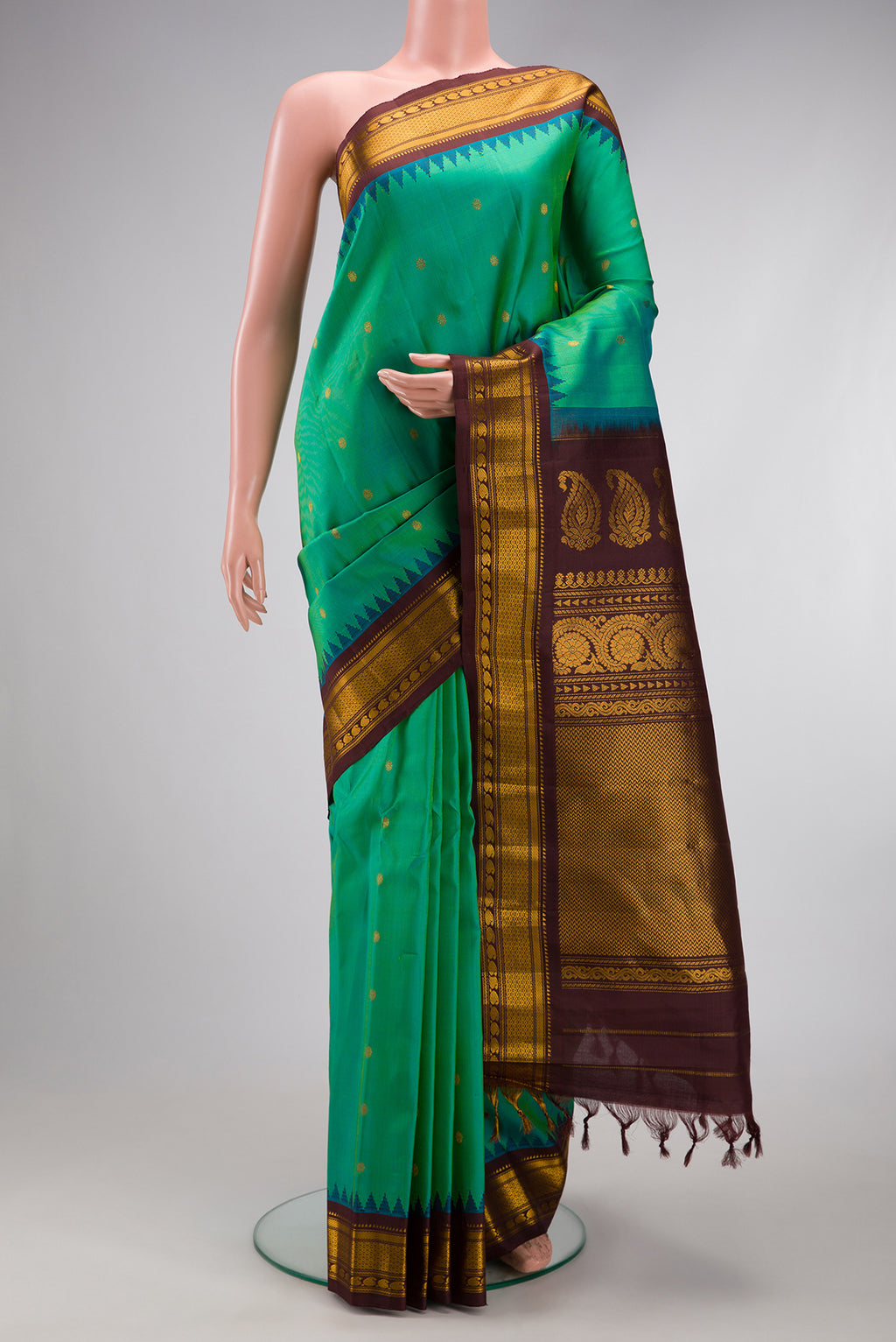 Sea Green Gadwal Silk Saree with Zari Butta on the body and Zari Border.  displayed on a mannequin