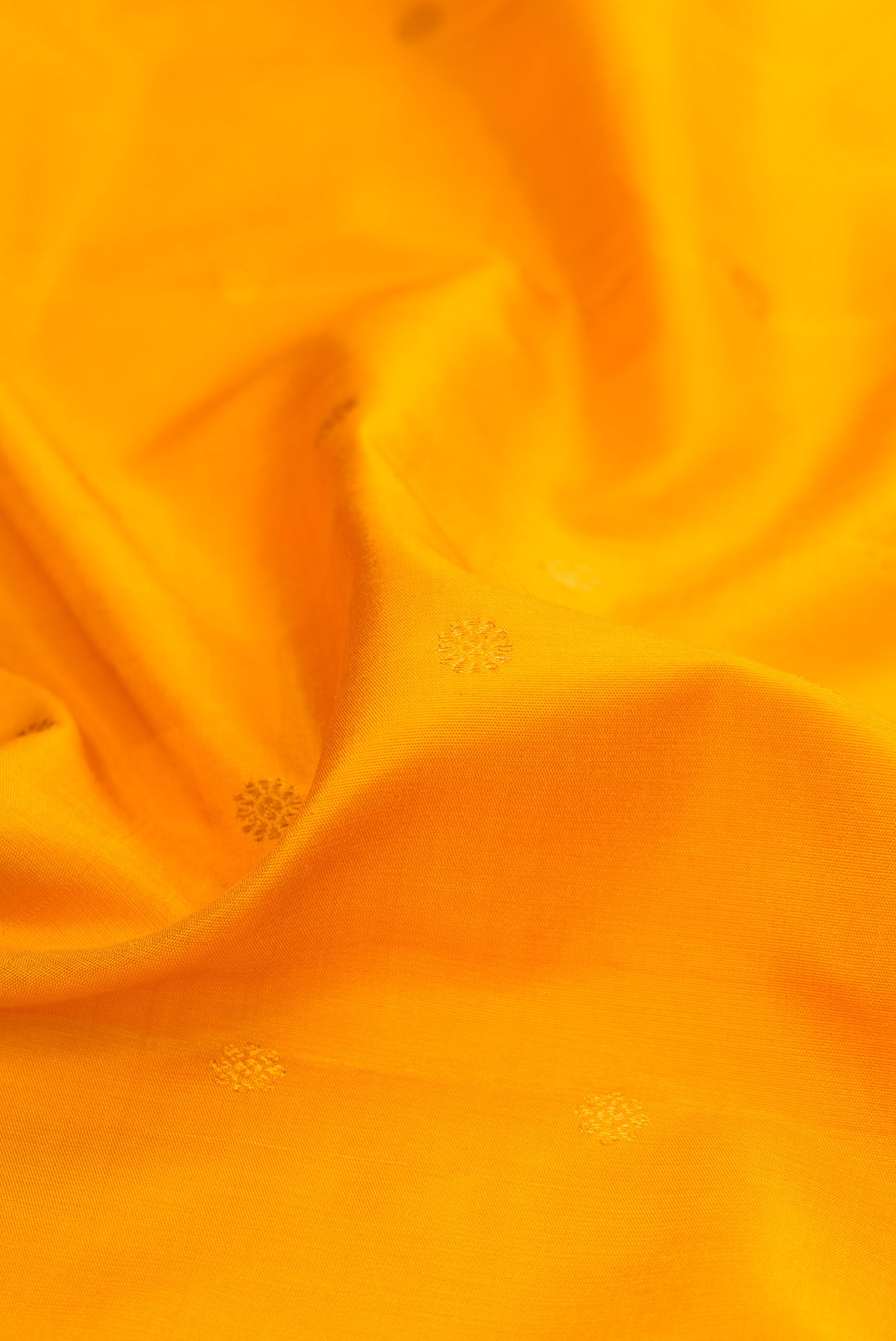 Close up of Yellow Gadwal Silk Saree with Zari Butta on the body and Zari Border.  displaying folds