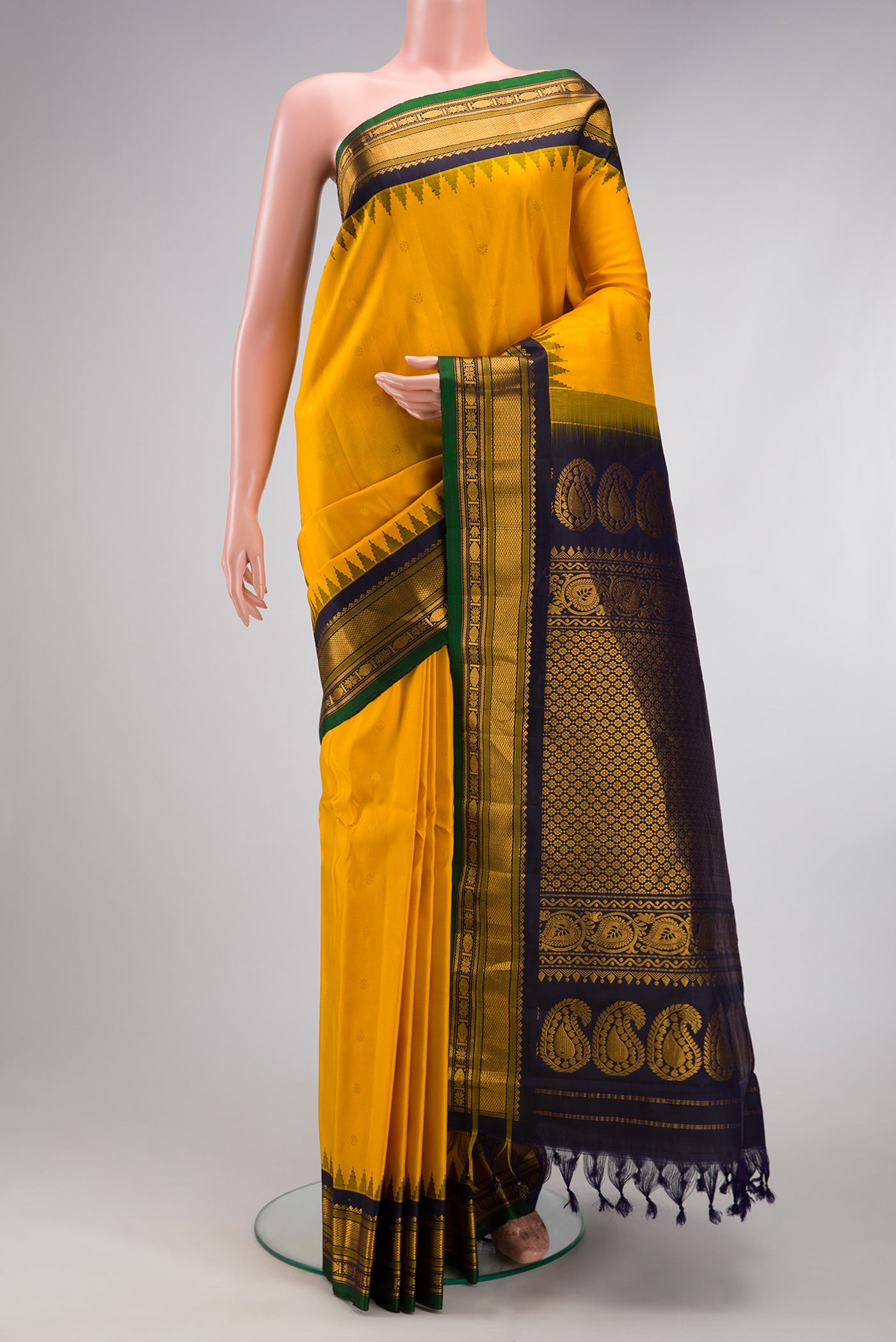 Yellow Gadwal Silk Saree with Zari Butta on the body and Zari Border.  displayed on a mannequin