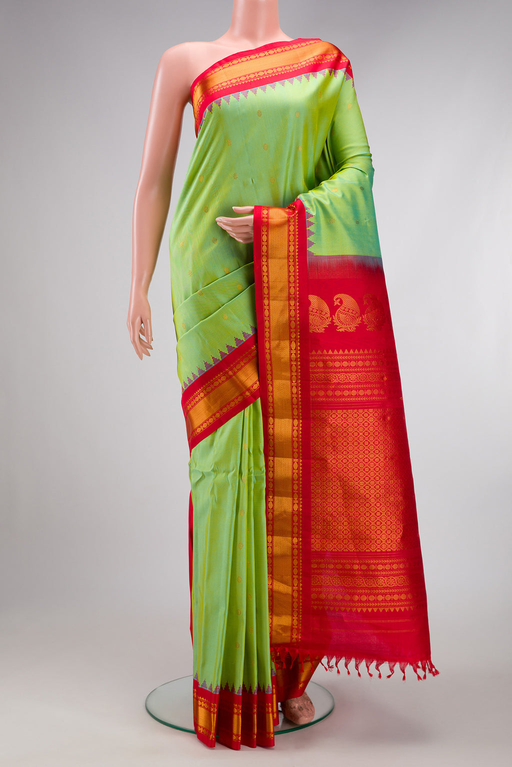 Pista Green Gadwal Silk Saree with Zari Butta on the body and Zari Border.  displayed on a mannequin