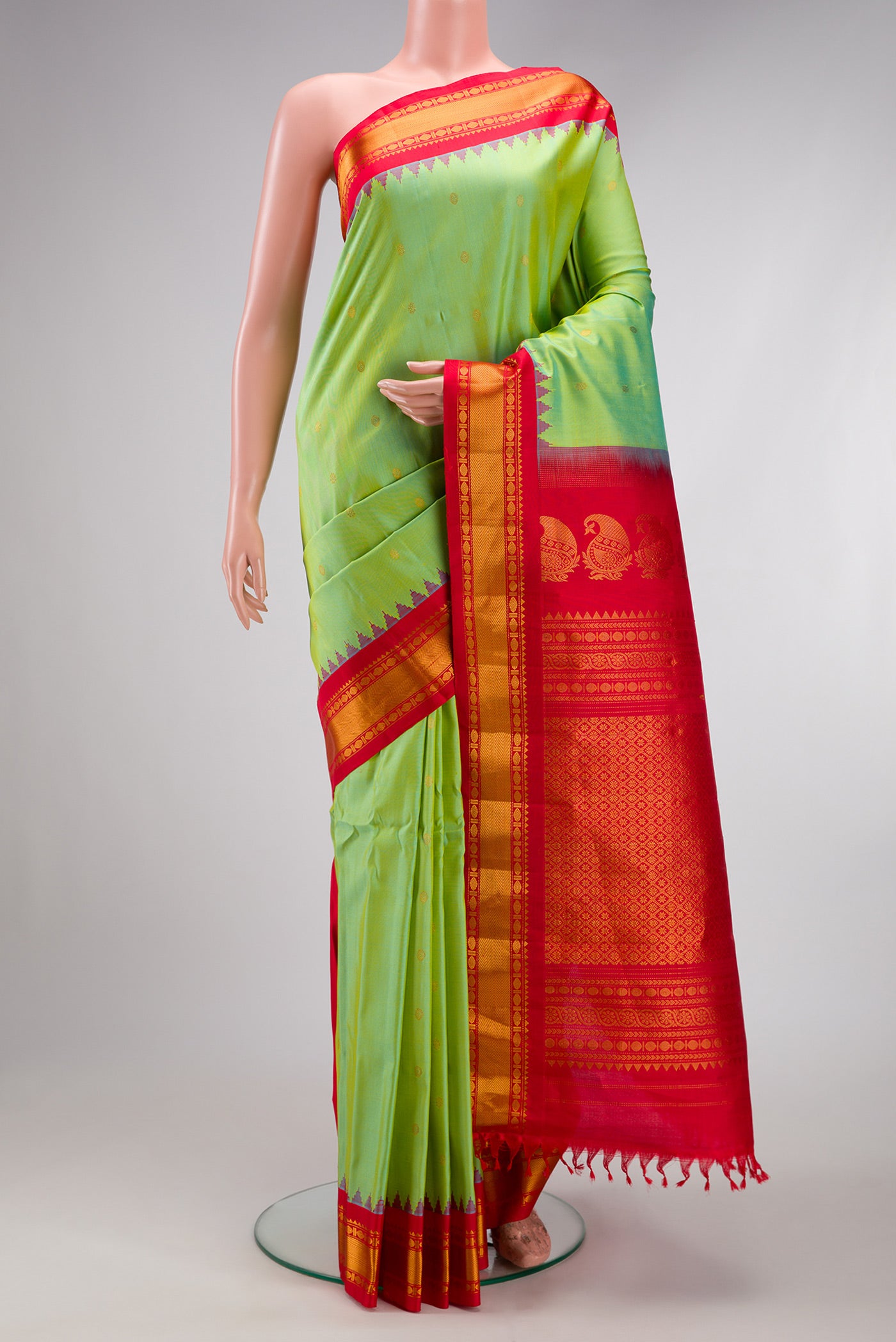 Pista Green Gadwal Silk Saree with Zari Butta on the body and Zari Border.  displayed on a mannequin