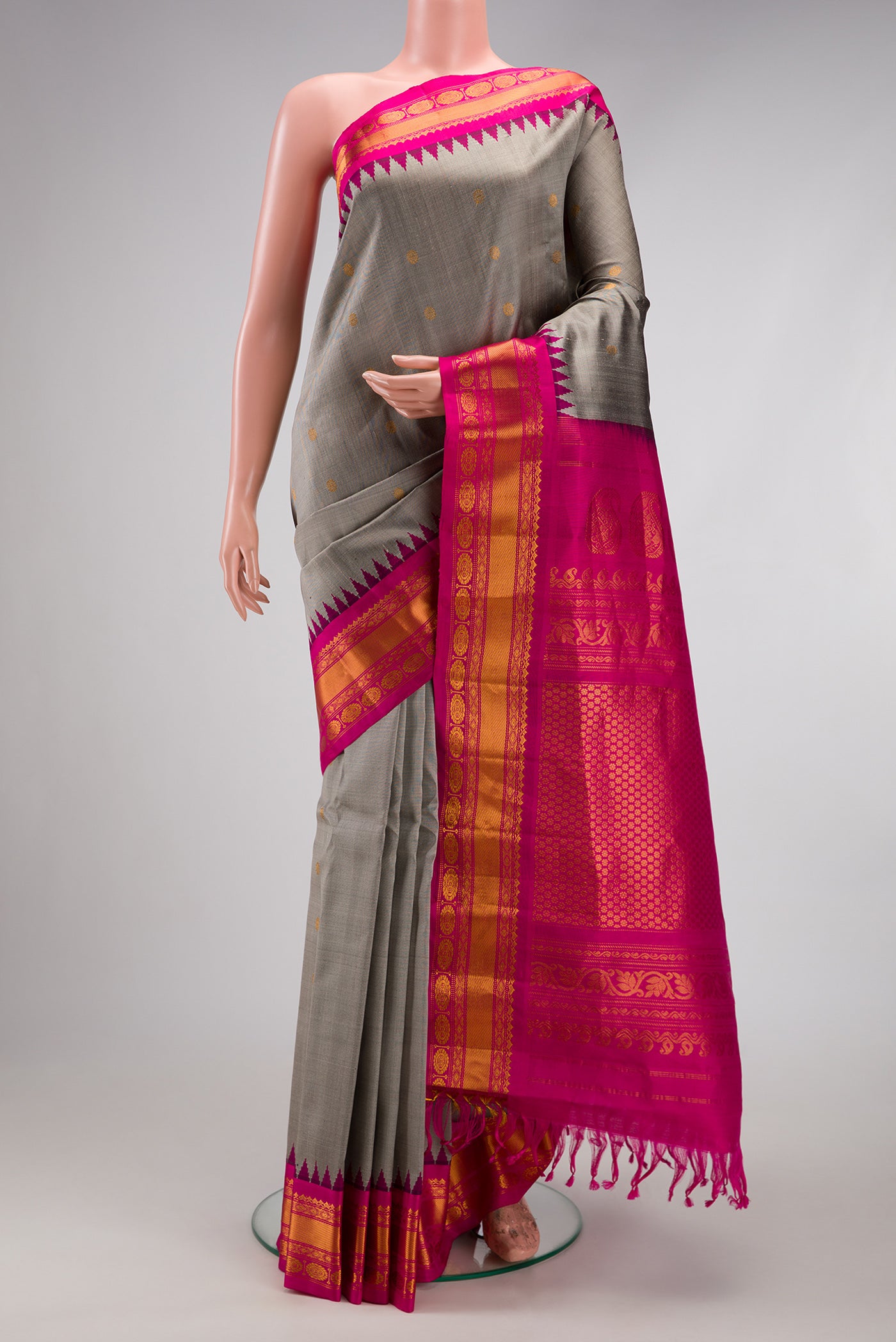 Grey Gadwal Silk Saree with Zari Butta on the body and Temple Border.  displayed on a mannequin