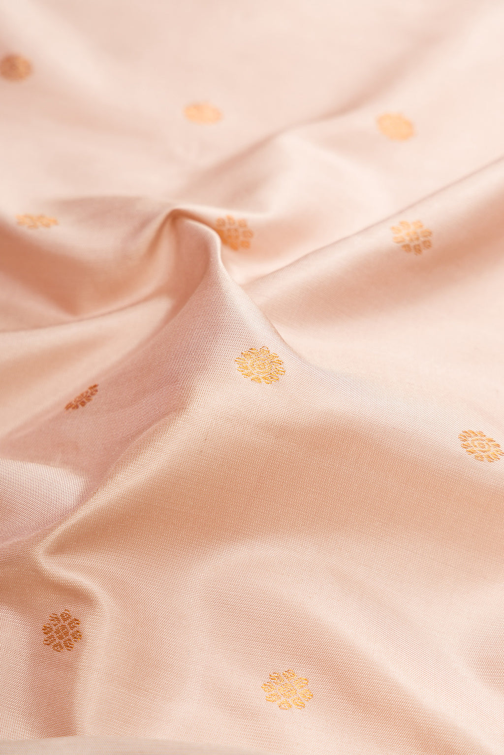 Close up of Dark Beige Gadwal Silk Saree with Zari Butta on the body and Zari Border.  displaying folds