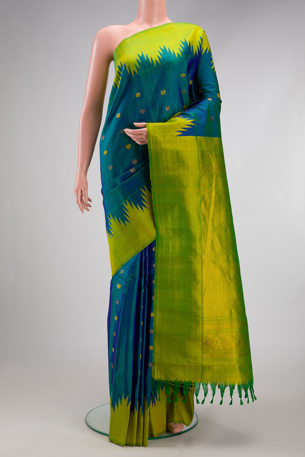 Peacock Blue Gadwal Silk Saree with Zari Butta on the body and Temple Border.  displayed on a mannequin