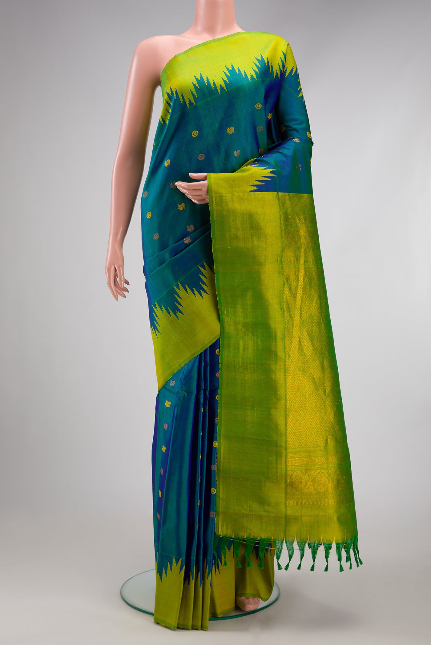 Peacock Blue Gadwal Silk Saree with Zari Butta on the body and Temple Border.  displayed on a mannequin