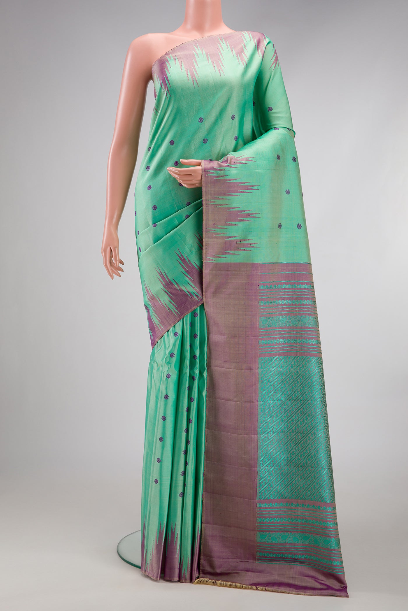 Sea Green Gadwal Silk Saree with Thread Butta on the body and Temple Border.  displayed on a mannequin